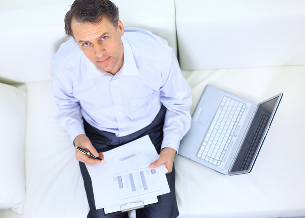 Entrepreneur working from home looking very relaxed in his sofa browsing th - Photo, image