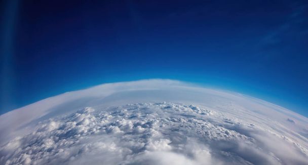 Aerial view. Blue sky over heavy cloudscape. Space, science and weather concept - Фото, изображение