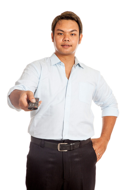 Asian man point a remote control to camera - Zdjęcie, obraz