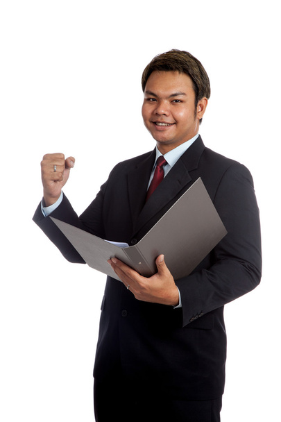 Asian businessman open a report and hold his fist with success - Foto, Imagem