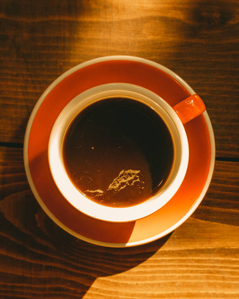 cup of coffee on wooden table - 写真・画像