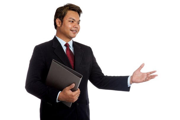 Asian businessman hold a folder talking to someone - Фото, зображення