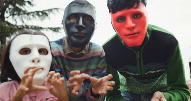 a group of kids in masks in the park - Фото, зображення