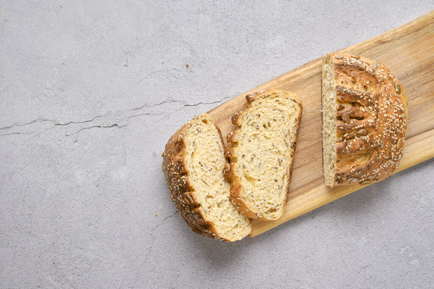 Fresh oats bread with sunflower seeds and sesame on wooden table - Φωτογραφία, εικόνα