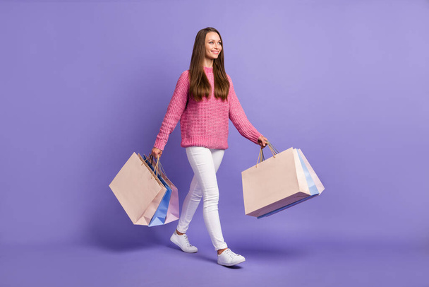 Full body profile portrait of adorable person hands hold bags look empty space isolated on purple color background. - Foto, immagini
