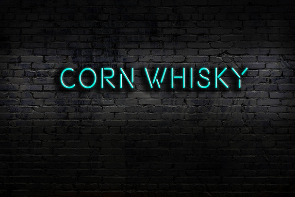Neon sign with inscription corn whisky against brick wall. Night view - Zdjęcie, obraz
