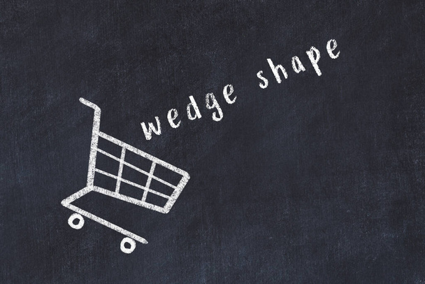 Chalk drawing of shopping cart and word wedge shape on black chalboard. Concept of globalization and mass consuming. - Foto, afbeelding