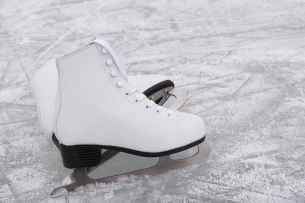 Pair of figure skates on ice, space for text - Foto, immagini