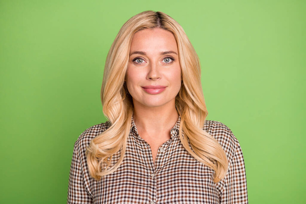 Portrait of attractive content cheerful blond woman wearing checked shirt isolated over bright green color background. - Foto, Bild