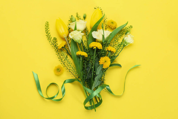 Beautiful bouquet of flowers on yellow background - Photo, image