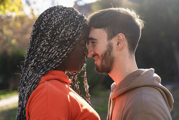A romantic multiracial couple close forehead to forehead - Fotoğraf, Görsel
