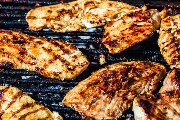 Chicken and pork steak grilled on a charcoal barbeque. Top view of camping tasty barbecue, food concept, food on grill and detail of food on the grill - Photo, Image
