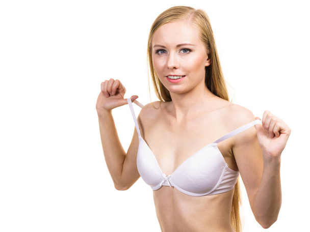 Young slim woman holding bra strap. Straps keep falling down problem. Female breast in lingerie. Bosom and underwear concept. - Φωτογραφία, εικόνα