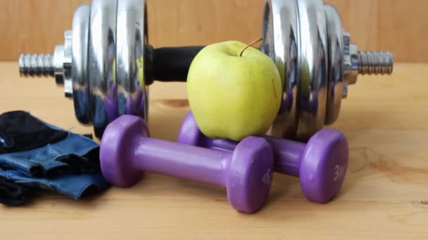 Healthy lifestyle. Dumbbells on a wooden background.  - Filmati, video