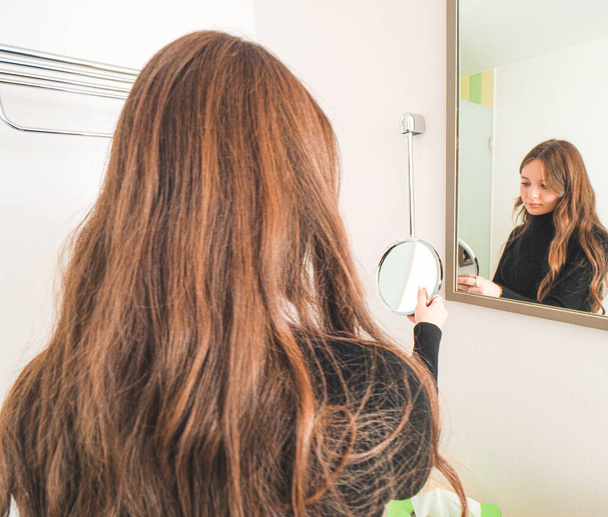 young woman with hair dryer in bathroom - Fotoğraf, Görsel