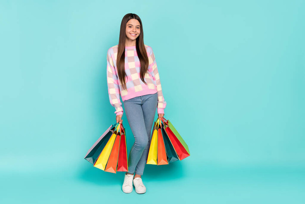 Photo of dreamy sweet girl wear pink sweater holding shopping bargains isolated turquoise color background - Foto, Imagen