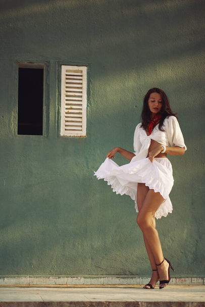 Dancing Woman in Elegant Summer Outfit Outdoors Against House Background - Fotó, kép