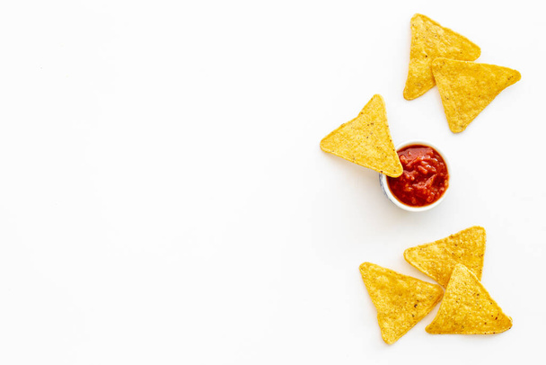 Mexican food nachos chips with tomato salsa sauce, top view - Zdjęcie, obraz
