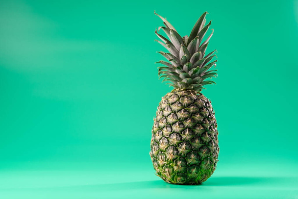 Creative copy space mockup with tropical fruit pineapple. For writing text in the concept of food on a green background. - Φωτογραφία, εικόνα