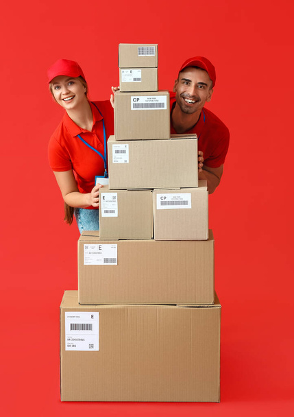 Couriers with many parcels on color background - Zdjęcie, obraz
