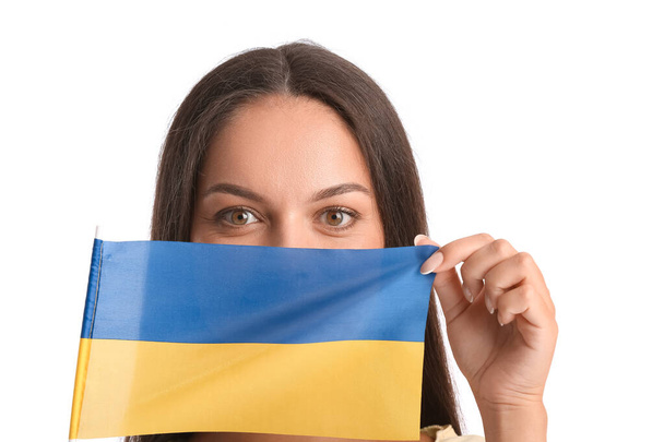 Beautiful young woman with flag of Ukraine on white background - Foto, imagen