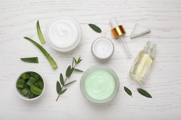 Body cream and cosmetic products, eucalyptus with aloe on white wooden table, flat lay - Zdjęcie, obraz