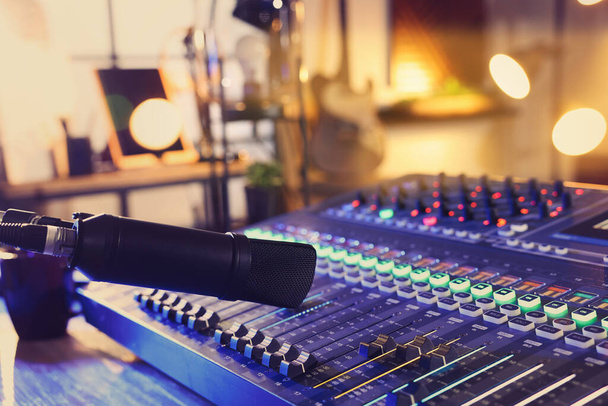 Microphone over professional mixing console on table in radio studio - Фото, изображение