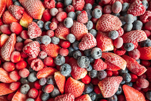frozen mix strawberries blueberries raspberries and cranberries closeup - Zdjęcie, obraz