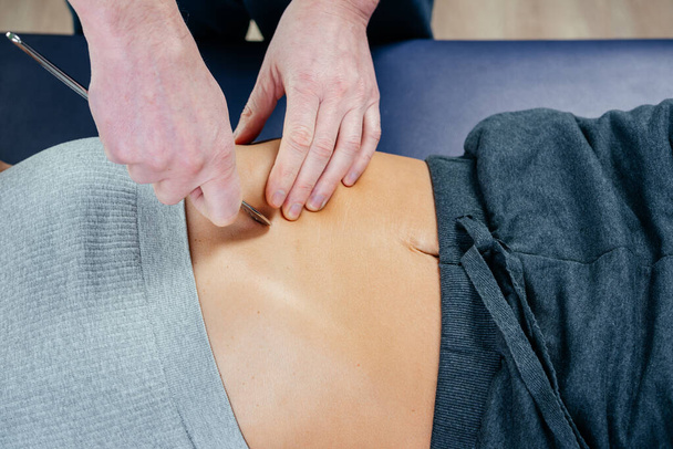 Chiropractic diaphragm myofascial release with IASTM tool, osteopath releasing tension in diaphragm muscles - Photo, Image