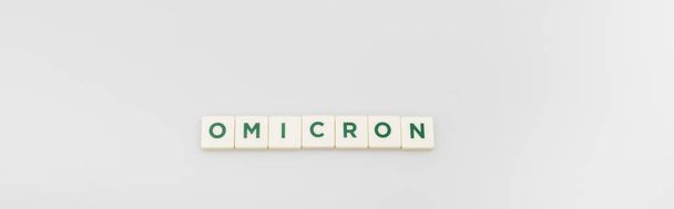 top view of white cubes with omicron lettering on grey background, banner - Фото, изображение