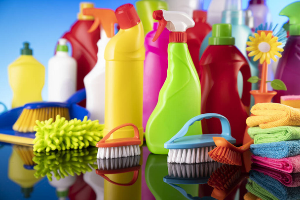 House  and office cleaning products. Colorful cleaning kit on blue background. - Фото, изображение