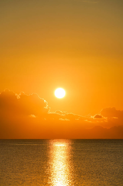 Vertical Seascape, Big sun in sunset sky at the lake with clouds. - Foto, imagen