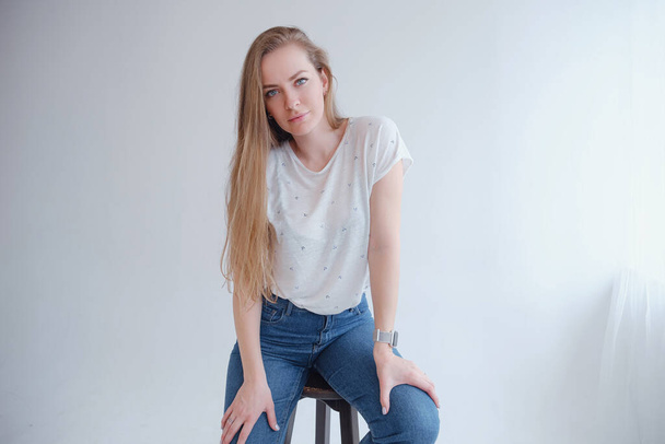 beautiful blonde young woman posing in a photo studio. - Φωτογραφία, εικόνα