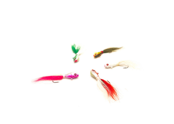 Colorful mix of bucktail Jig heads lure with hydrodynamic head, oversized painted eyes and features isolated on white background. Hand tie deer hair fishing jig hooks - Foto, Bild