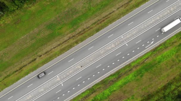 a straight section of the road by road high-speed highway. aerial view top down - Materiał filmowy, wideo