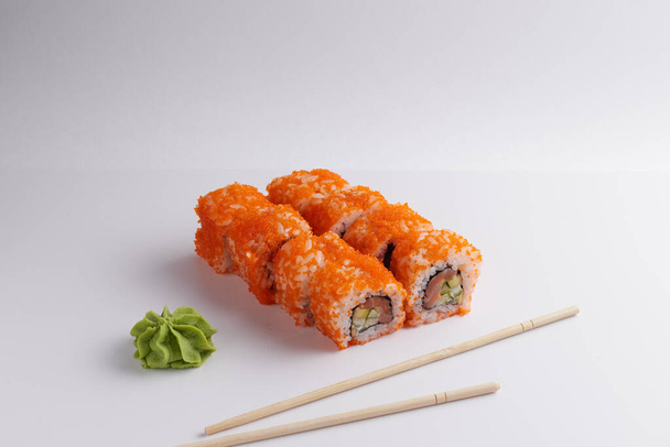 a portion of rolls on a stand, japanese food, sushi on the table, chinese chopsticks, light background - Photo, Image