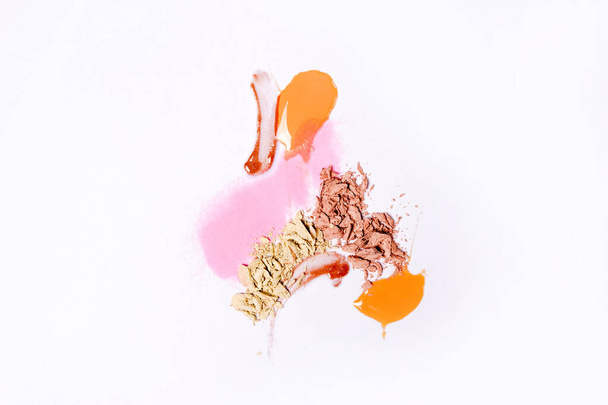 Smears of different colors are made with various cosmetic products isolated on a white background. Texture of multi-colored strokes - Photo, Image