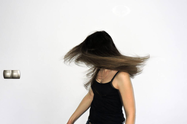 A view of a young girl's very long wavy brown hair with blond streaks in motion, white background - Fotoğraf, Görsel