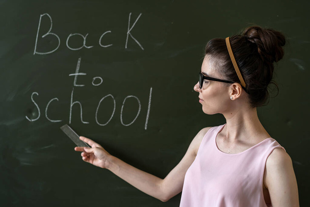 Teacher near at the blackboard, writen back to school, education concept - Foto, afbeelding