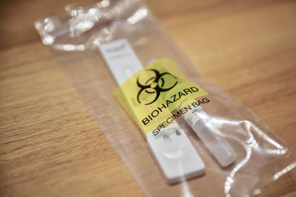 Closeup of a used corona test kit in a plastic bag. - Foto, Bild