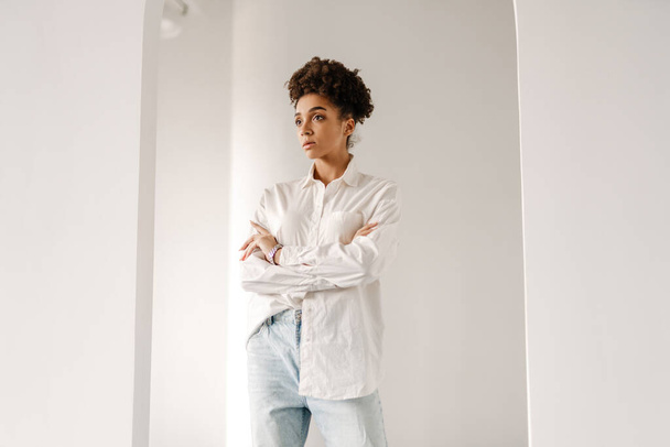 Young black woman standing and looking aside indoors - Photo, Image