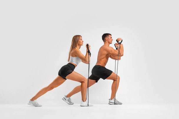 Fit couple at the gym isolated on white background. Fitness concept. Healthy life style. - Foto, imagen