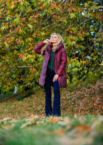 Woman wear warm jacket. Jackets everyone should have. Best puffer coat to buy. How pick puffer jacket. Puffer fashion concept. Professional stylist advice. Girl fashionable blonde walk in autumn park - Foto, Imagem