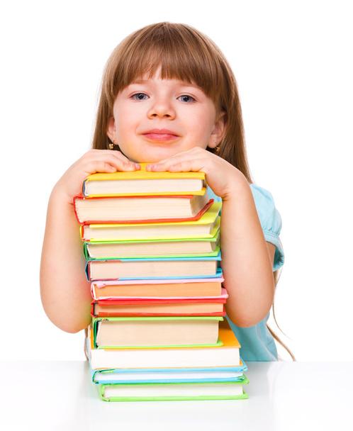 Cute girl is reading book - Фото, изображение