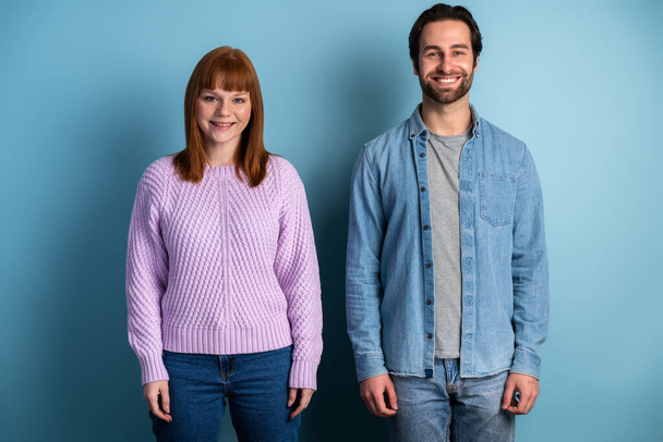 Photo of pretty lady and handsome guy couple one team members reliable workers posing isolated over blue color background  - Valokuva, kuva