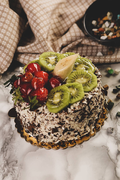Board with delicious cake on table - Фото, изображение