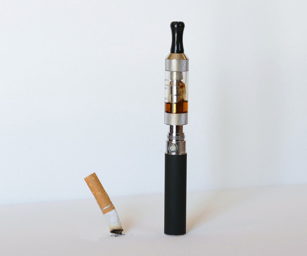 Electronic cigarette with extinguished tobacco cigarette - Photo, Image