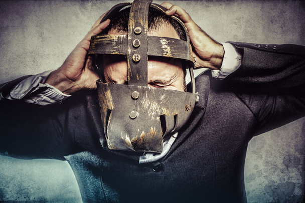 Dangerous business man with iron mask - Foto, Imagen