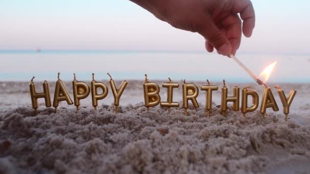 Man lights candle with match. Candles Gold Letters Happy Birthday Burning - Filmati, video
