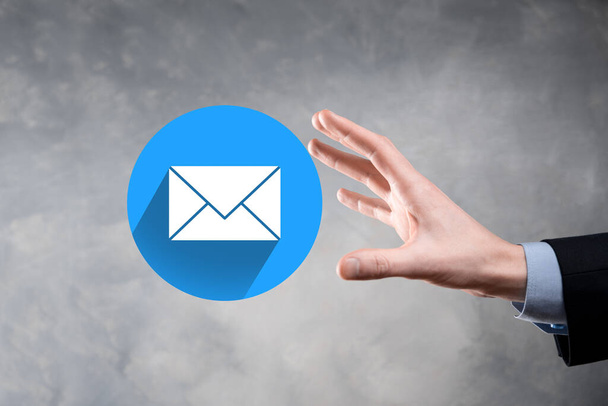 Businessman hand holding letter icon,email icons.Contact us by newsletter email and protect your personal information from spam mail.Customer service call center contact us.Email marketing newsletter - Photo, Image